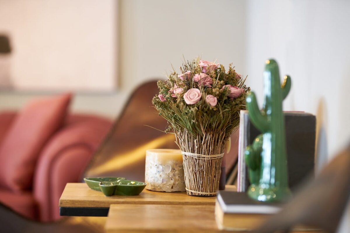 service-02 Elegant floral arrangement on a wooden table in a modern cozy interior setting.